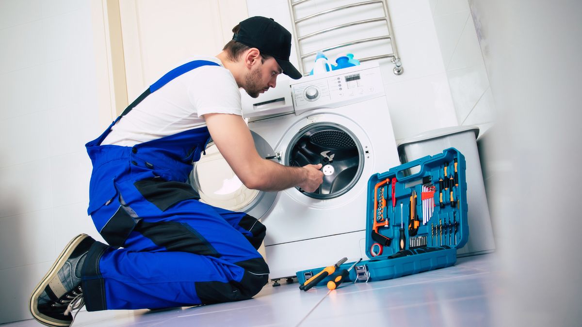 Washing machine technician servicing machine Cape Town